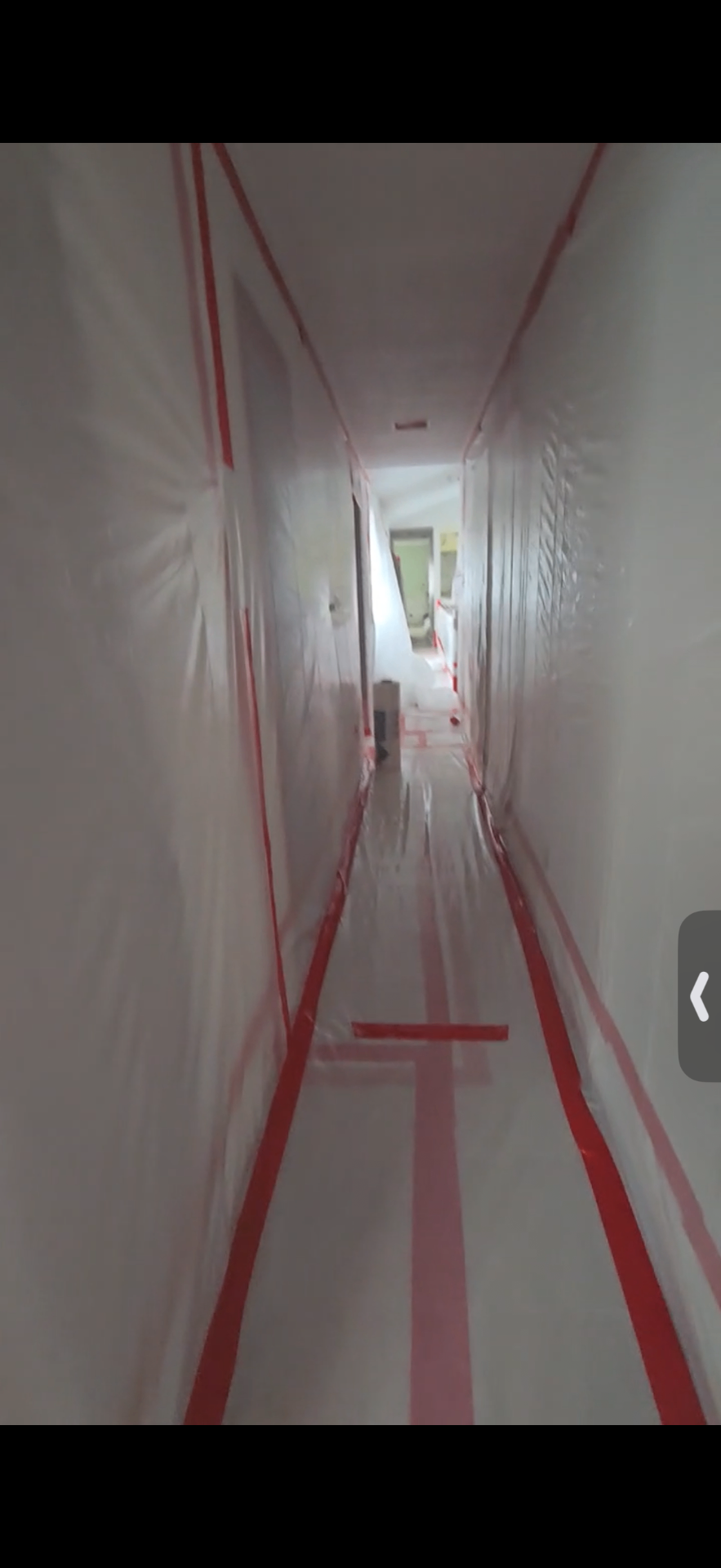 Sealed plastic containment built by Advantage Environmental along a residential hallway before hazardous material removal