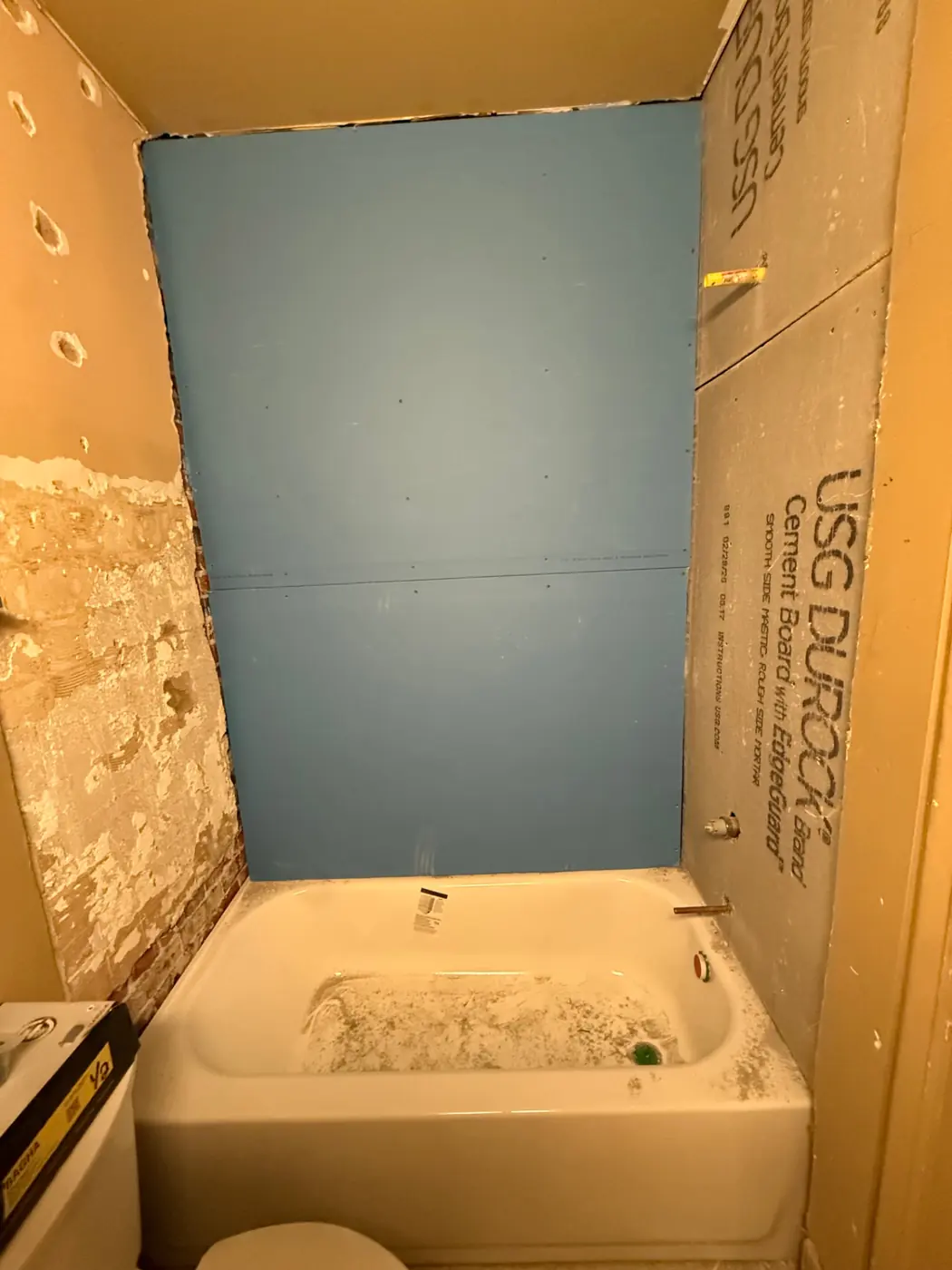 USG Durock cement board and mold resistant board installed around a new bathtub in a Denver bathroom rebuild